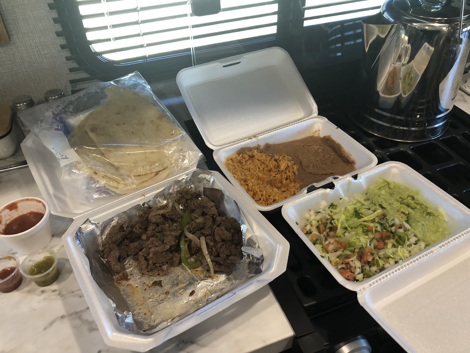One pound fajitas to-go order with homemade tortillas, rice, beans and guacamole